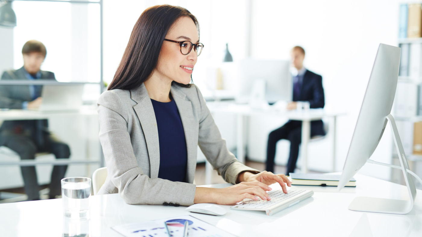 Smiling accountant entering data in office