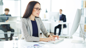 Smiling accountant entering data in office