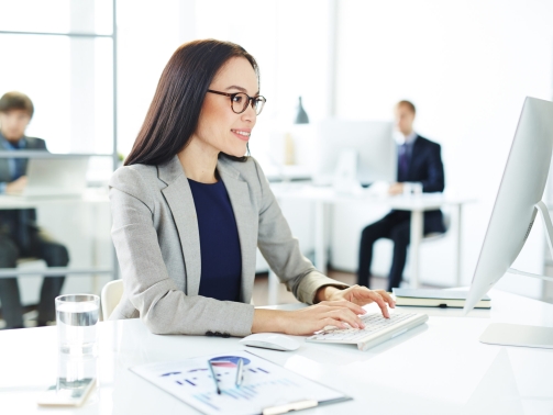 Smiling accountant entering data in office