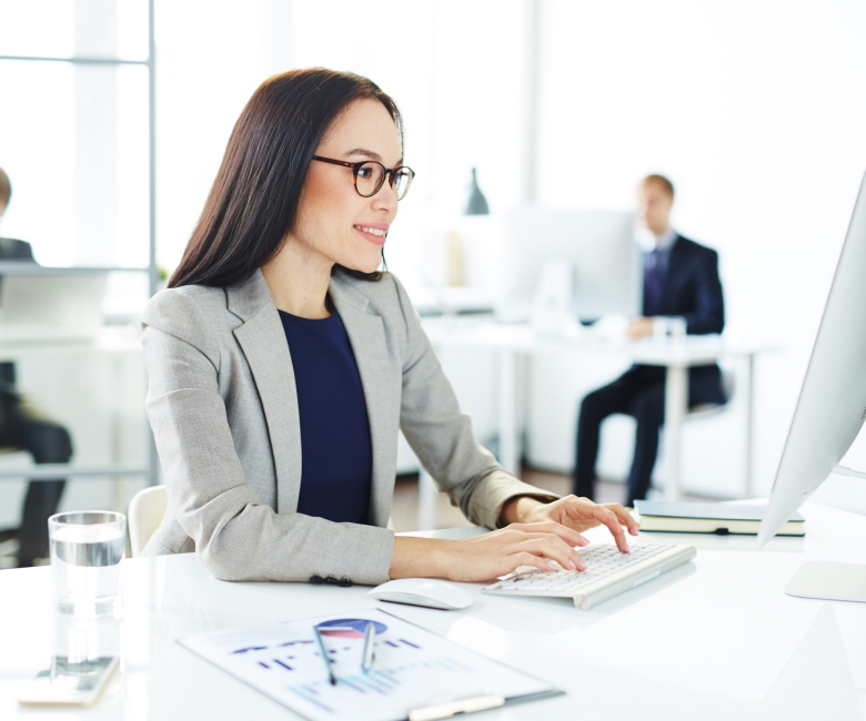 Smiling accountant entering data in office
